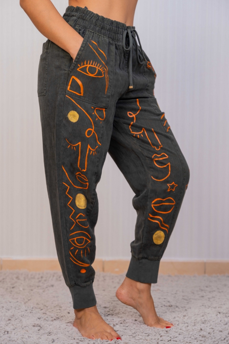 Picture of Dark green women's jeans with an African print