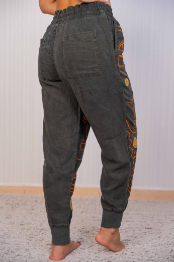 Picture of Dark green women's jeans with an African print